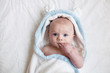 © kknox/Stocksy - baby wrapped in a hooded towel