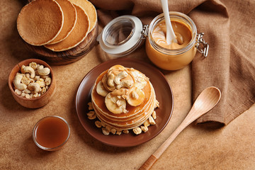 Poster - Plate with yummy banana pancakes on kitchen table