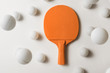 © Marko Milanovic/Stocksy - Orange pIng pong racket and white balls flying