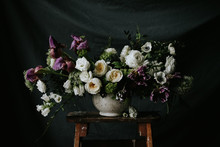 Dark And Moody Purple And White Wedding Flower Arrangement With Dark Background
