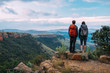 © Micky Wiswedel/Stocksy - Hikers on a mountain summit enjoying the view of a scenic valley