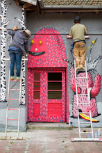 Two Graffiti Artists On Ladders