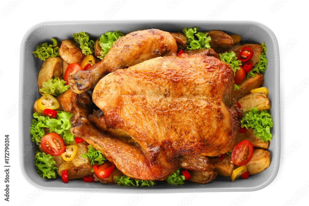 Baking dish with roasted turkey and vegetables on white background