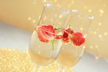 Poster - Glasses of delicious wine with strawberry on blurred background