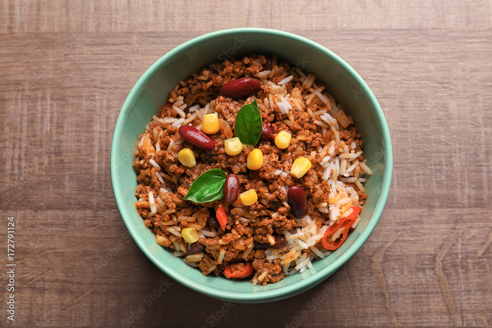 Chili con carne in bowl on wooden background