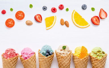 Fototapete - Various of ice cream flavor in cones blueberry ,strawberry ,pistachio ,almond ,orange and cherry setup on white wooden background . Summer and Sweet menu concept.