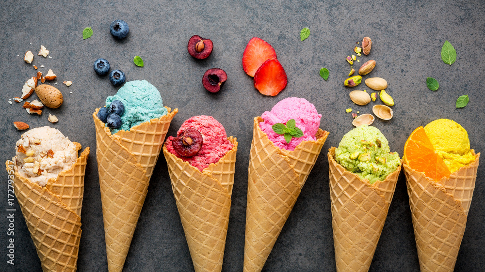 Various of ice cream flavor in cones blueberry ,strawberry ,pistachio ,almond ,orange and cherry setup on dark stone background . Summer and Sweet menu concept. - obrazy, fototapety, plakaty 