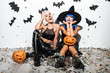© Drobot Dean - Two pretty young women in leather halloween costumes