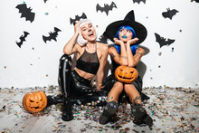Two Pretty Young Women In Leather Halloween Costumes