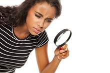 Beautiful Young Dark Skinned Woman Looking Trough The Magnifying Glass