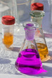 chemical or medical glassware filled with colorful liquids on a white table
