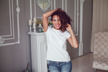 Wall Mural - Curly haired girl with freckles in blank white t-shirt. Mock up.