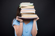© Catalin Pop - Young student hiding behind her school books