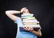© Catalin Pop - Stressed college student carrying a stack of books