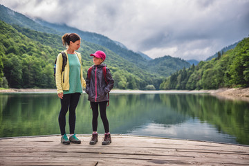 Wall Mural - Mother and daughter standing on the pier