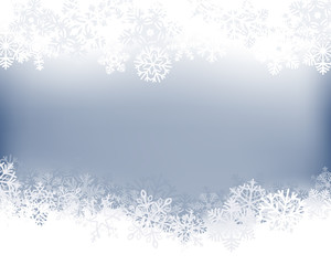 Wall Mural - Winter background. White  border made of fluffy snowflakes with space for text on soft blue background .
