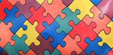 Bright Wall Of Colorful Jigsaw Puzzles. Abstract Background