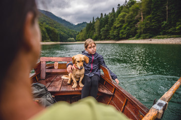 Wall Mural - Mother and daughter with a dog rowing a boat