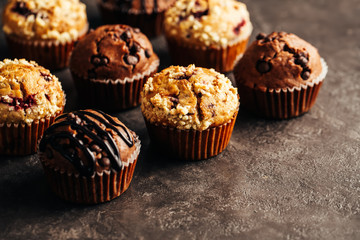 Different homemade muffins, selective focus. Copy space.