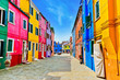 View of the colorful Venetian houses along the canal at the Islands of Burano in Venice.