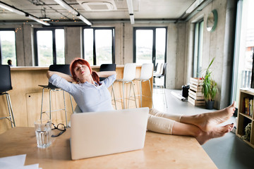 Businesswoman with laptop in her office.