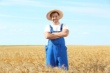 Canvas Print - Young male farmer standing in wheat field