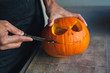© Cindy Prins/Stocksy - Carving a pumpkin for halloween
