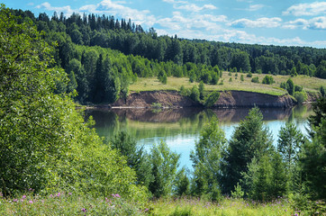 Wall Mural - summer beautiful landscape of the hilly banks of the river, green grass, forest.