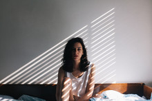 Portrait Of Brunette Woman In Her Bed In The Morning