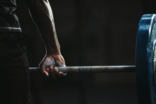 Close-up Of A Man's Hand Lifting Barbell