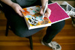 © Jennifer Brister/Stocksy - Artist creating colorful art on messy table