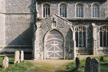 White Gated Door On A Rural Church. Norfolk, UK.
