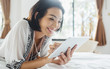 © Lumina/Stocksy - Woman Using a Tablet in Bed in the Morning