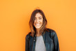 © Guille Faingold/Stocksy - Portrait of cheerful brunette looking at camera