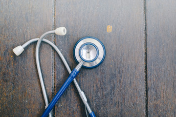 Stethoscope over wooden background for medical and health care concept