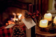 romantic bottle of wine and Christmas presents by cozy fireplace