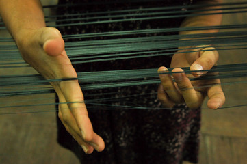 Wall Mural - women's hands in the process of weaving cloth