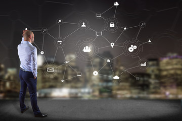 Poster - businessman in front of a wall with a business network connection displayed on a futuristic interfac