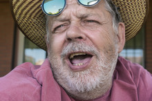 Close-up Portrait Of Bearded Singing Senior Man