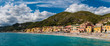 Panoramic view of Varigotti, small sea village near Savona, with crowded beach during a sunny afternoon