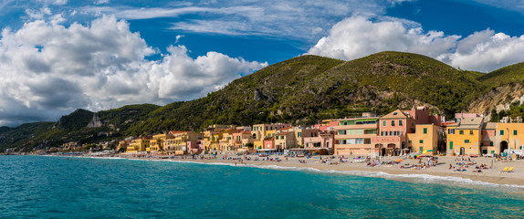 Wall Mural - Panoramic view of Varigotti, small sea village near Savona, with crowded beach during a sunny afternoon