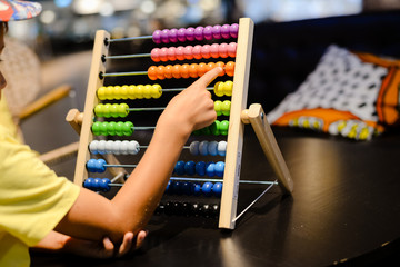 Close up on colorful abacus playful activity, educational interior background. Happy joyful developmental lifestyle