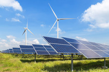 Solar Panels And Wind Turbines Generating Electricity In Power Station Green Energy Renewable With Blue Sky Background 