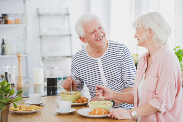 Wall Mural - Woman in pink shirt is eating milk soup