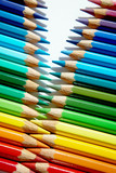 Fototapeta Tęcza - Colored pencils of various colors standing in a zigzag against each other.
