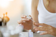 Closeup on woman's hands applying nail polish
