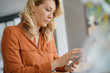 © goodluz - Middle-aged blond woman using smartphone