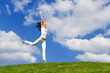 © Dmytro Sunagatov - Happy young woman jumping on green grass. Landscape of grass field on bright sunny day. Nature beauty background, blue cloudy sky and summer green meadow. Outdoor lifestyle. People freedom concept