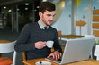 © Mosuno/Stocksy - Young Businessman Working in a Cafe