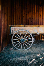 A Old Carriage Against A Stained Wood Wall